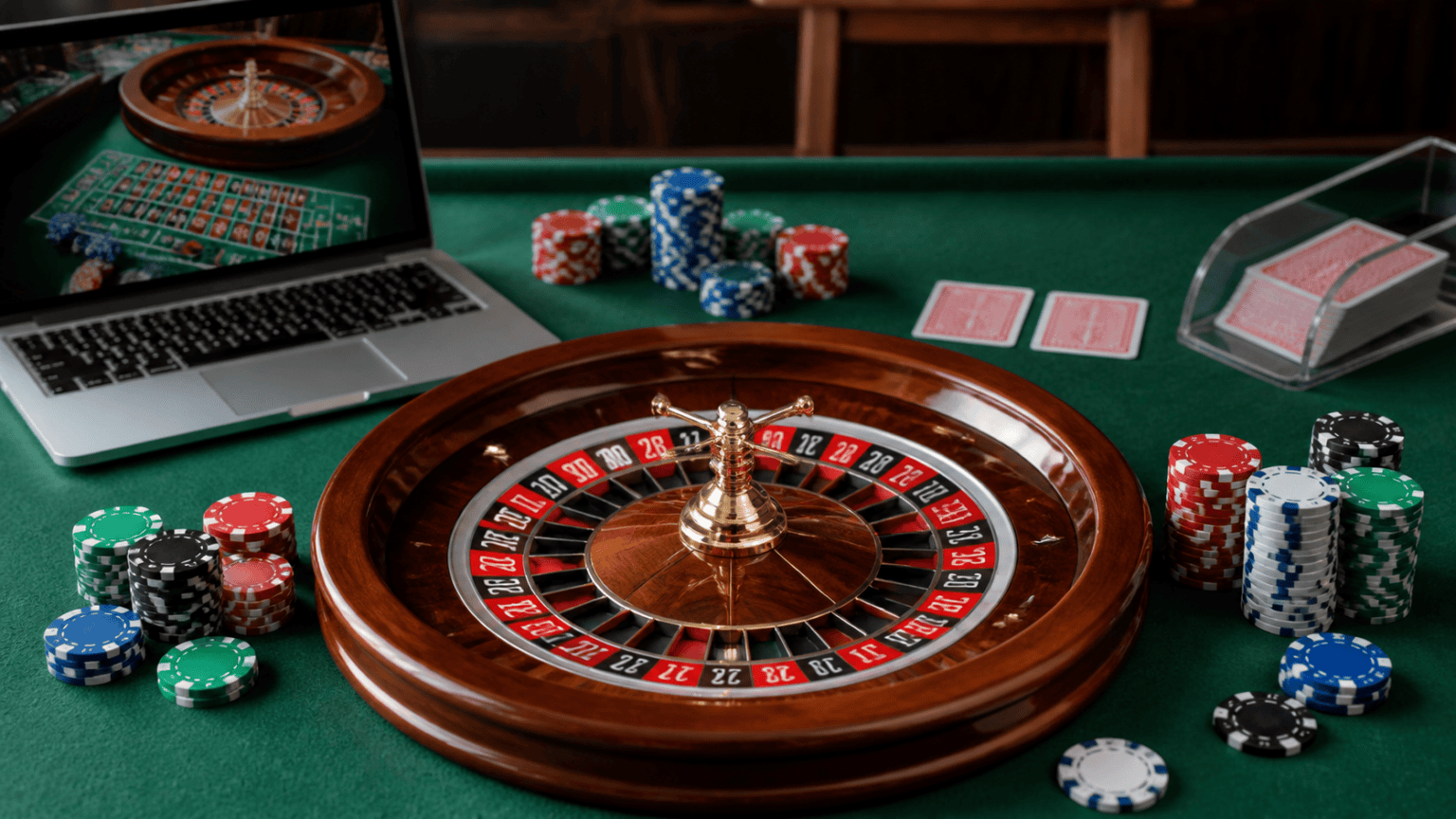 Mengenali Game Judi Online dalam Industri Kasino Moden Laptop with casino games, poker chips, and cards for online betting Singapore